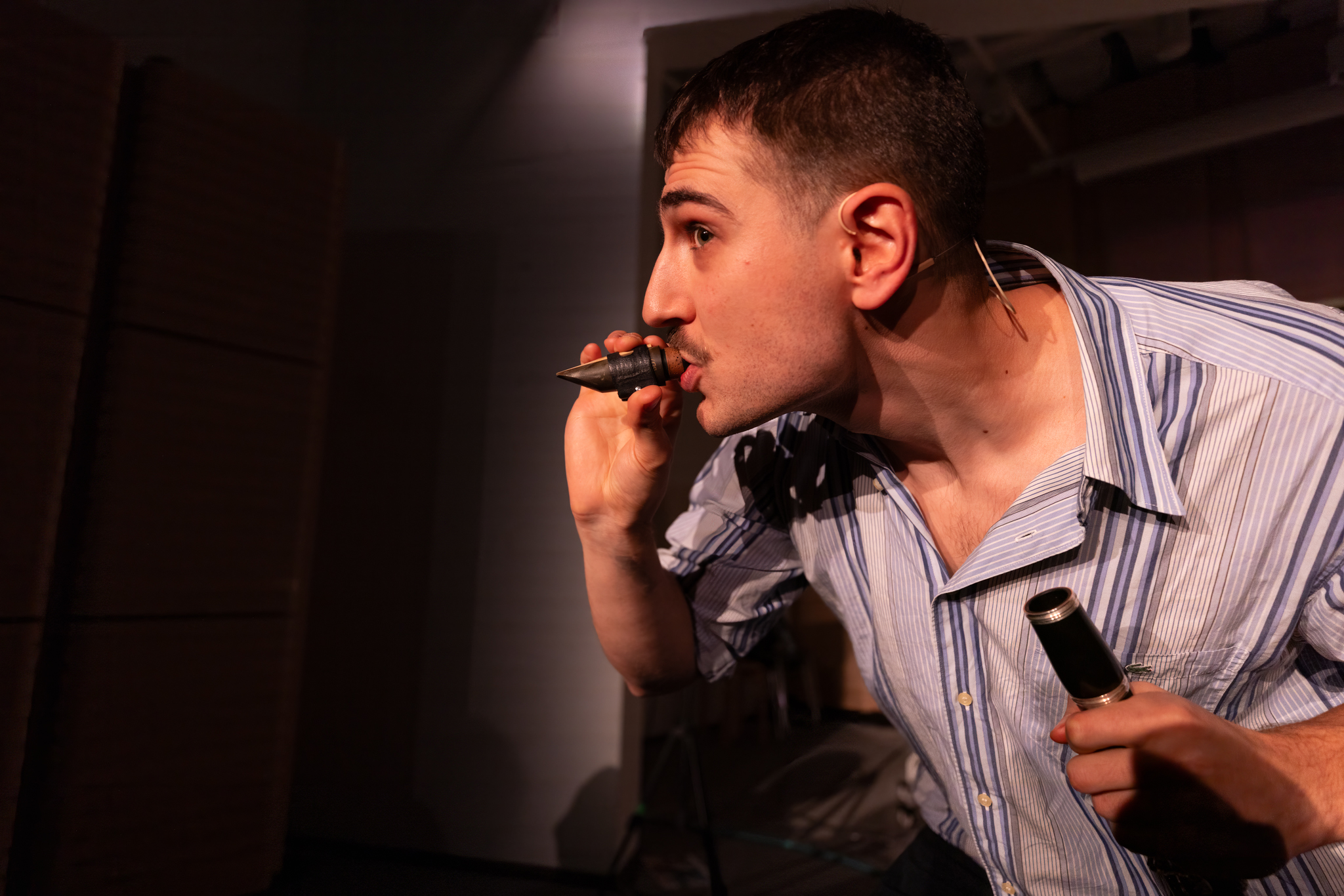 Solomon Frank blowing into the head of a clarient