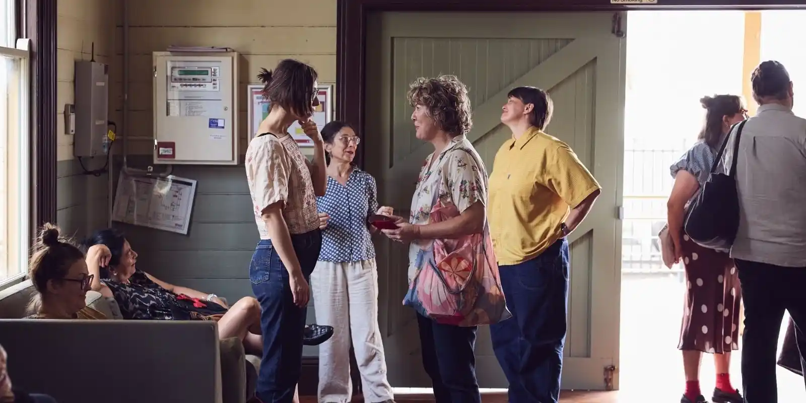 People standing in the lobby of a performance